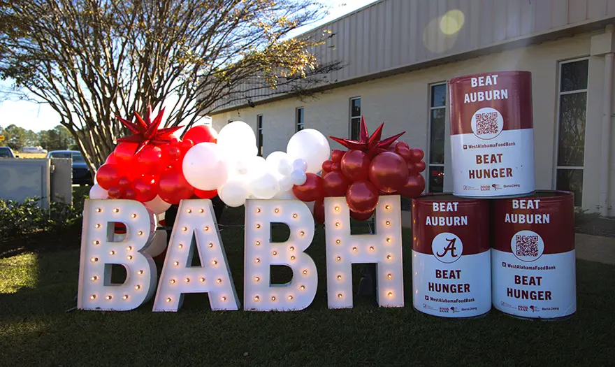 BABH letters in lights with balloons and BABH barrels